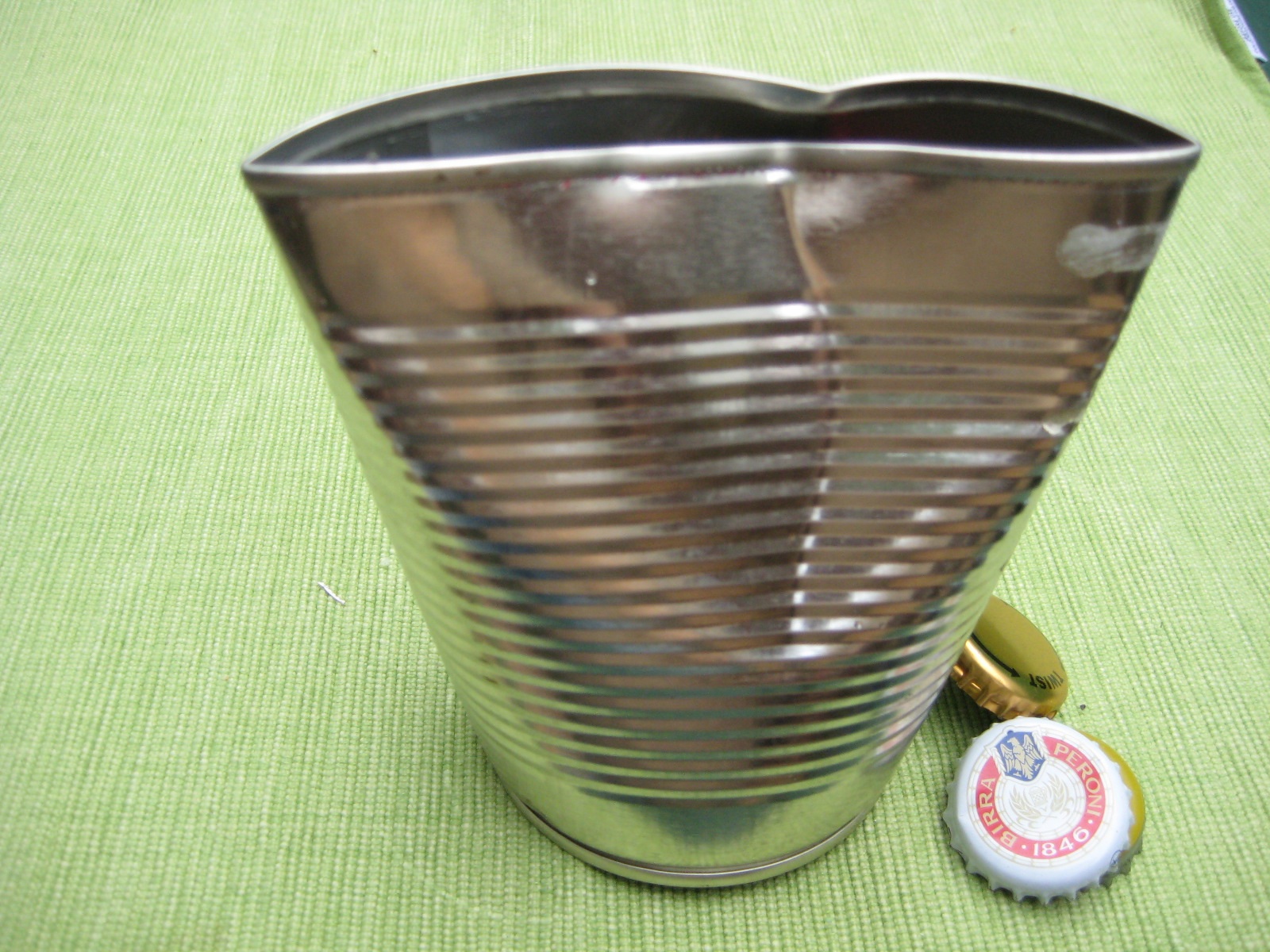 steel can with bottle tops in